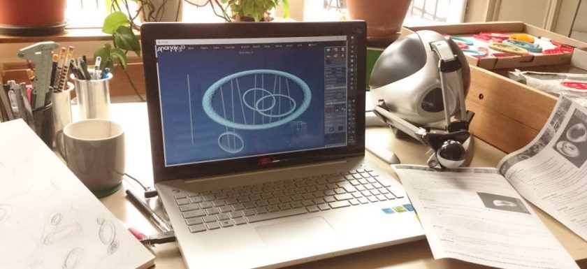 Image shows a laptop screen running Anarkik3DDesign, a 3D modelling programme runninh on both PC and Mac, using a haptic device to touch and feel your virtual 3D models