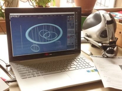 Image shows a laptop screen running Anarkik3DDesign, a 3D modelling programme runninh on both PC and Mac, using a haptic device to touch and feel your virtual 3D models
